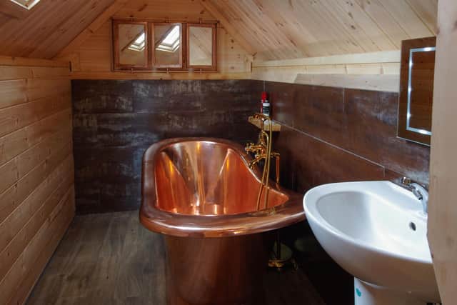 The copper bathtub in the bathroom.