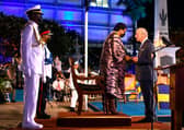 TOPSHOT - Charles, Prince of Wales (R) receives the Order of Freedom of Barbados from President of Barbados Dame Sandra Mason (2nd R) during the ceremony to declare Barbados a Republic and the Inauguration of the President of Barbados at Heroes Square in Bridgetown, Barbados, on November 30, 2021. - Fireworks filled the sky over Barbados as the Caribbean island nation declared itself the world's newest republic, lowering Queen Elizabeth's flag as it severed colonial-era ties to the British throne to the sound of jubilant gun salutes. (Photo by Randy Brooks / AFP) (Photo by RANDY BROOKS/AFP via Getty Images)