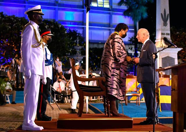 TOPSHOT - Charles, Prince of Wales (R) receives the Order of Freedom of Barbados from President of Barbados Dame Sandra Mason (2nd R) during the ceremony to declare Barbados a Republic and the Inauguration of the President of Barbados at Heroes Square in Bridgetown, Barbados, on November 30, 2021. - Fireworks filled the sky over Barbados as the Caribbean island nation declared itself the world's newest republic, lowering Queen Elizabeth's flag as it severed colonial-era ties to the British throne to the sound of jubilant gun salutes. (Photo by Randy Brooks / AFP) (Photo by RANDY BROOKS/AFP via Getty Images)