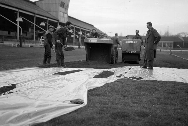Staff at Powderhall prepare a surface of red blaes for the traditional New Year Sprint in 1964.