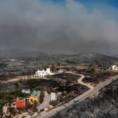 An aerial view shows smoke billowing in background of Kiotari village, on the island of Rhodes.