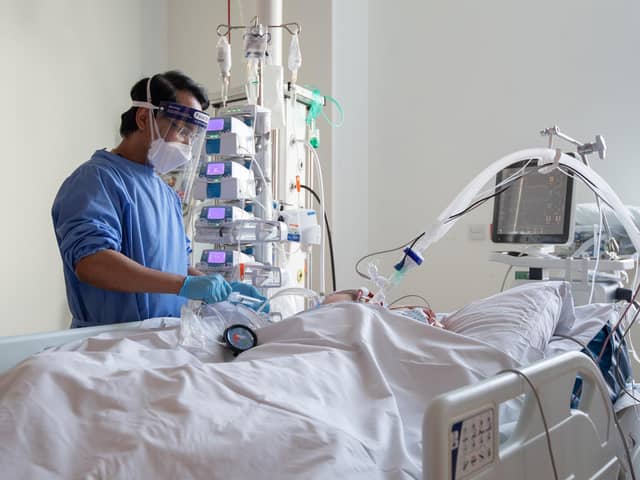 A nurse checking on a patient suffering with Covid-19 on the critical care unit.