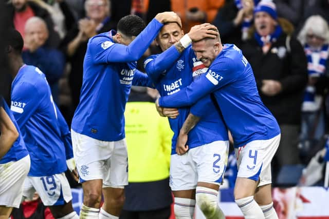 Rangers' James Tavernier celebrates with Leon Balogun and John Lundstram.