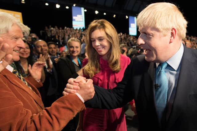Boris Johnson is congratulated by his father Stanley Johnson after delivering his keynote speech on the final day of the annual Conservative Party conference in Manchester in 2019 (Picture: Stefan Rousseau/pool/AFP via Getty Images)