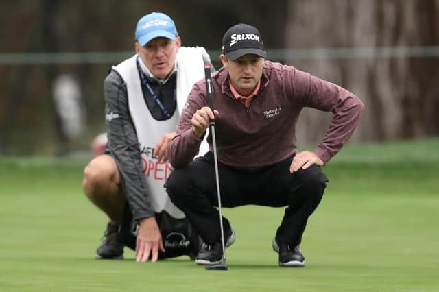 Russell Knox and his caddie line up a putt on the eighth hole during the first round of the Safeway Open at Silverado Resort in Napa, California. Picture: Jed Jacobsohn/Getty Images