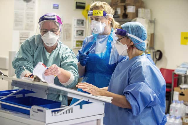 Staff attending to a patient in the ICU. Picture: Lisa Ferguson