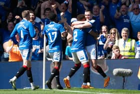 John Souttar is mobbed by his Rangers team-mates after scoring the second goal of the game against Celtic.