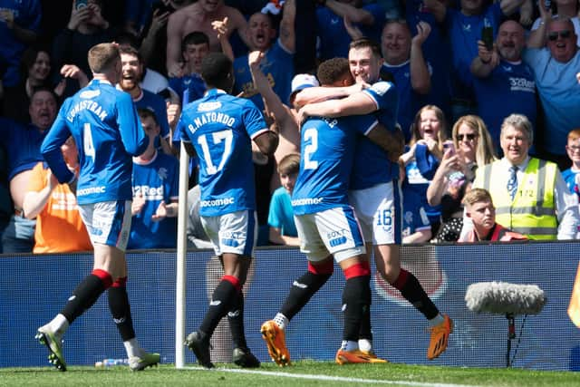 John Souttar is mobbed by his Rangers team-mates after scoring the second goal of the game against Celtic.