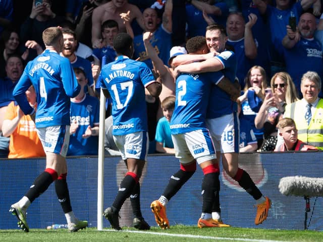 John Souttar is mobbed by his Rangers team-mates after scoring the second goal of the game against Celtic.