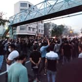 A picture obtained by AFP outside Iran shows Iranian demonstrators taking to the streets of the capital Tehran during a protest for Mahsa Amini, days after she died in police custody.