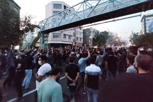 A picture obtained by AFP outside Iran shows Iranian demonstrators taking to the streets of the capital Tehran during a protest for Mahsa Amini, days after she died in police custody.