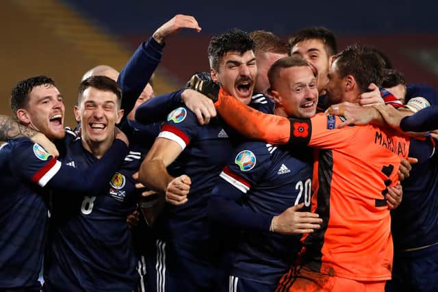 David Marshall (in orange) is mobbed by his Scotland team-mates after his penalty save in the shoot-out against Serbia ensured Scotland's qualification for Euro 2020, which will be played this summer. Picture: Srdjan Stevanovic/Getty Images