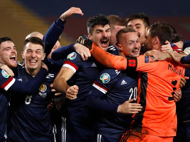 David Marshall (in orange) is mobbed by his Scotland team-mates after his penalty save in the shoot-out against Serbia ensured Scotland's qualification for Euro 2020, which will be played this summer. Picture: Srdjan Stevanovic/Getty Images