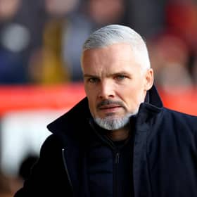 Jim Goodwin, who insists he just needs time to complete Aberdeen's "transition" rather than assurances over his job following Wednesday's 5-0 defeat by Hearts.