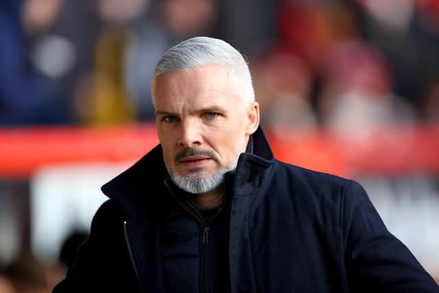 Jim Goodwin, who insists he just needs time to complete Aberdeen's "transition" rather than assurances over his job following Wednesday's 5-0 defeat by Hearts.