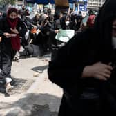 Women flee after Taliban fighters beat them and fire bullets into the air to break up a protest in Afghanistan's capital Kabul in August last year (Picture: Wakil Kohsar/AFP via Getty Images)