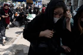 Women flee after Taliban fighters beat them and fire bullets into the air to break up a protest in Afghanistan's capital Kabul in August last year (Picture: Wakil Kohsar/AFP via Getty Images)