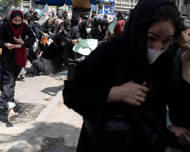 Women flee after Taliban fighters beat them and fire bullets into the air to break up a protest in Afghanistan's capital Kabul in August last year (Picture: Wakil Kohsar/AFP via Getty Images)