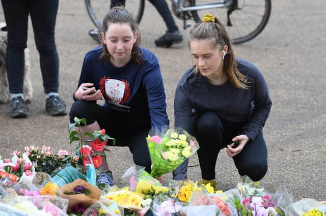 People leave floral tributes at the bandstand on Clapham Common, London, for Sarah Everard. A serving police constable has been charged with kidnapping and murdering the 33-year-old marketing executive (Picture: Kirsty O'Connor/PA)