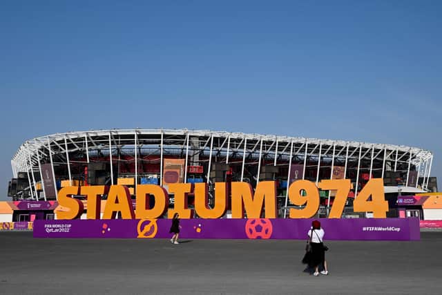Tourists stand in front the Stadium 974 in Doha on November 19, 2022, ahead of the Qatar 2022 World Cup.