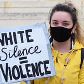 Peggy McIntosh who popularised the term, wrote "I was taught to see racism only in individual acts of meanness, not in invisible systems conferring dominance on my group." Pictured: A young protester at a Black Lives Matter protest in Swindon.