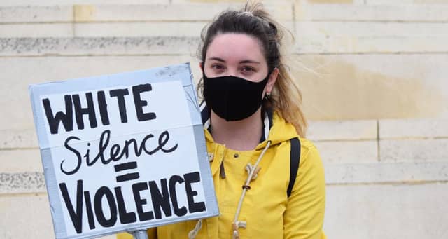 Peggy McIntosh who popularised the term, wrote "I was taught to see racism only in individual acts of meanness, not in invisible systems conferring dominance on my group." Pictured: A young protester at a Black Lives Matter protest in Swindon.