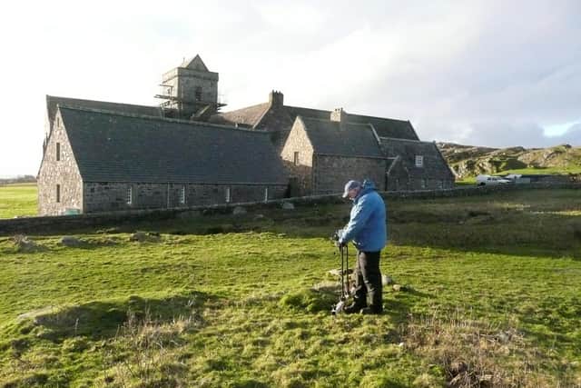 An archaeologist at work in the shadows of Iona Abbey. PIC: National Trust for Scotland.