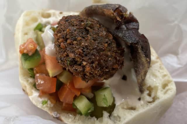 Falafel in pitta with onion, garlic, tahini, salad and aubergine, at Hakosem falafel in Tel Aviv. Pic: PA Photo/Jemma Crew.