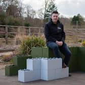 Andrew Vincent with the building blocks, which are made from recycled plastic. Picture: 360 Bid