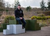Andrew Vincent with the building blocks, which are made from recycled plastic. Picture: 360 Bid