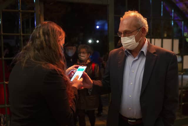 A man presents his "green passport," proof that he is vaccinated against the coronavirus at the Khan Theater in Jerusalem, Israel. Picture: AP Photo/Maya Alleruzzo