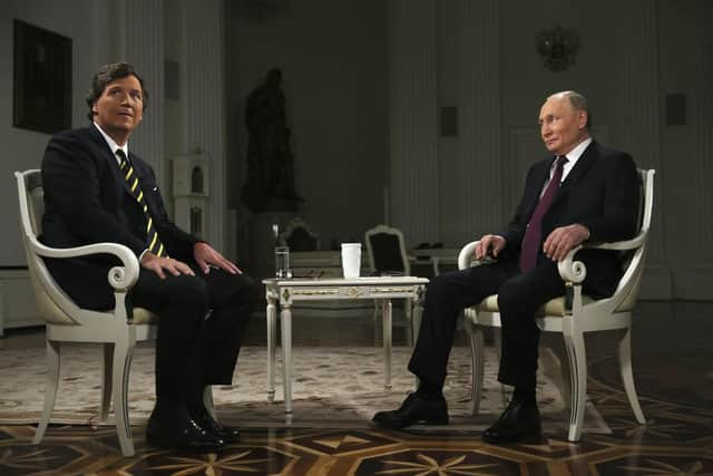 Russian president Vladimir Putin and former Fox News host Tucker Carlson prepare for an interview at the Kremlin in Moscow. Picture: Gavriil Grigorov, Sputnik, Kremlin Pool Photo via AP