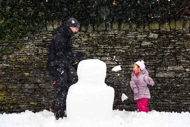 A child plays in the snow at Auchterarder as heavy snow blankets the streets.