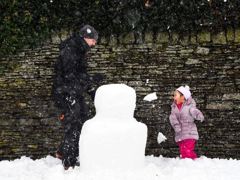 A child plays in the snow at Auchterarder as heavy snow blankets the streets.