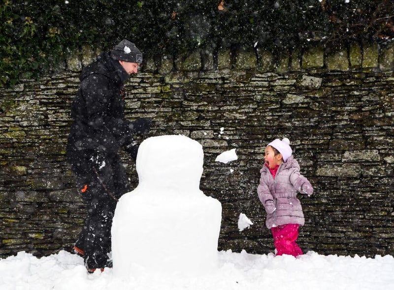 A child plays in the snow at Auchterarder as heavy snow blankets the streets.