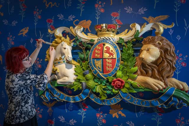Conservation officer Anna Zwagerman  cleans Queen Victoria's Coat of Arms plaque (1848) which forms part of the temporary exhibition ‘Unicorn' at Perth Museum. PIC: Jane Barlow/PA.