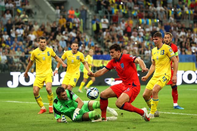 Georgiy Bushchan of Ukraine and Harry Maguire of England battle for possession. (Photo by Maja Hitij/Getty Images)