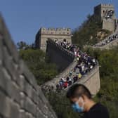 A man stands near a stretch of the Badaling Great Wall of China on the outskirts of Beijing. Authorities in China arrested the two men for smashing a path through a section of the ancient wall, a cultural icon and United Nations protected heritage site. Picture: AP Photo/Ng Han Guan