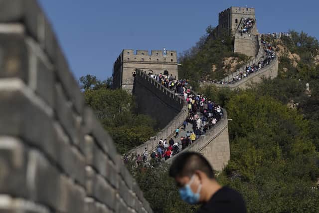 A man stands near a stretch of the Badaling Great Wall of China on the outskirts of Beijing. Authorities in China arrested the two men for smashing a path through a section of the ancient wall, a cultural icon and United Nations protected heritage site. Picture: AP Photo/Ng Han Guan
