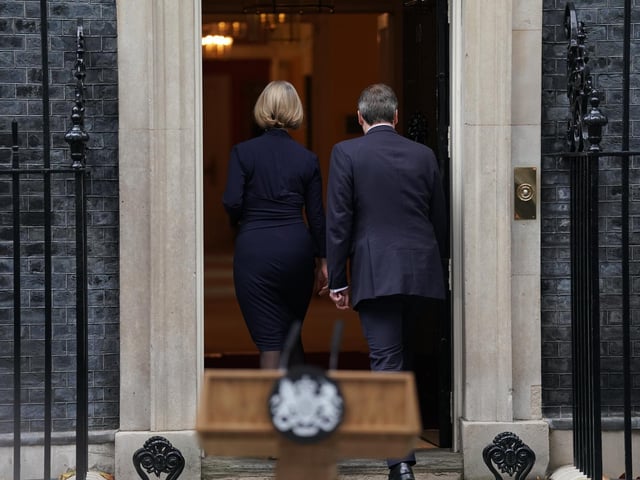 Liz Truss, with her husband Hugh O'Leary, walks back into 10 Downing Street, London, after making a statement where she announced her resignation as Prime Minister.