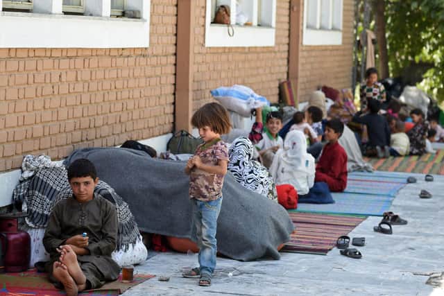 Afghan families who fled fighting between the Taliban and Afghan security forces sit in the courtyard of the Wazir Akbar Khan mosque in Kabul on Friday (Picture: Wakil Kohsar/AFP via Getty Images)