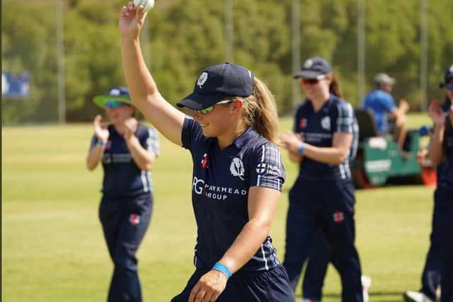 Megan McColl leaves the field with the match ball (CricketScotland/Tom Sole)