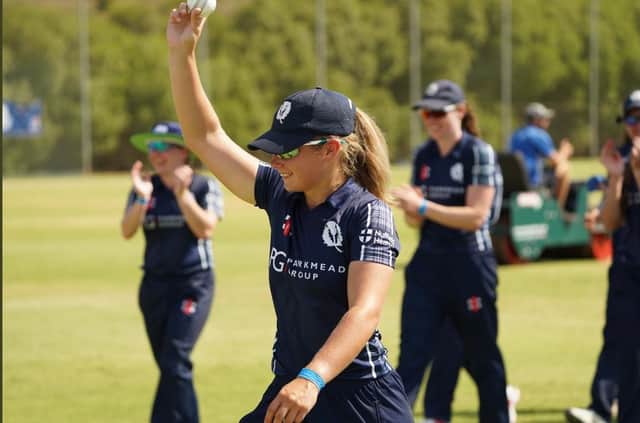 Megan McColl leaves the field with the match ball (CricketScotland/Tom Sole)