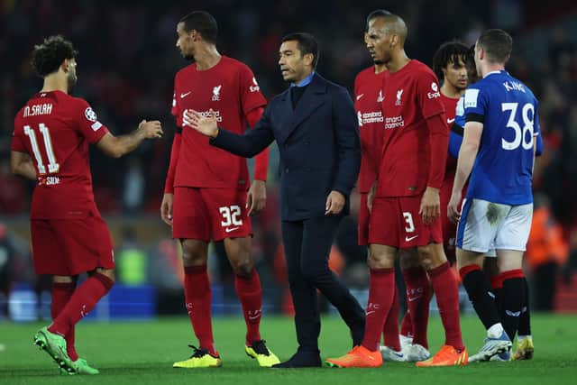Mohamed Salah of Liverpool interacts with Giovanni van Bronckhorst, Manager of Rangers after the UEFA Champions League group A match between Liverpool FC and Rangers FC at Anfield on October 04, 2022 in Liverpool, England. (Photo by Clive Brunskill/Getty Images)