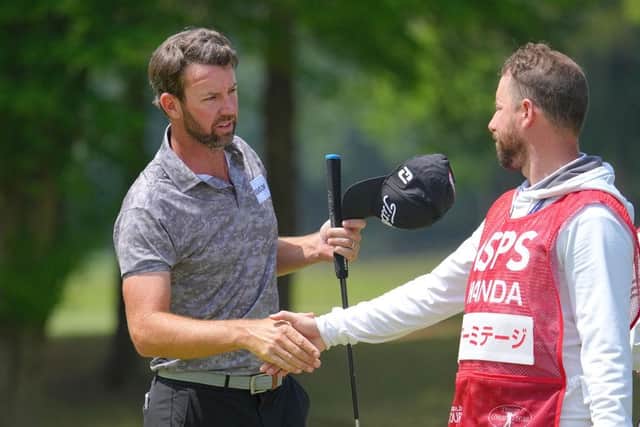 Scott Jamieson shakes hands with a caddie in his group after posting a four-under-par 66. Picture: Yoshimasa Nakano/Getty Images.