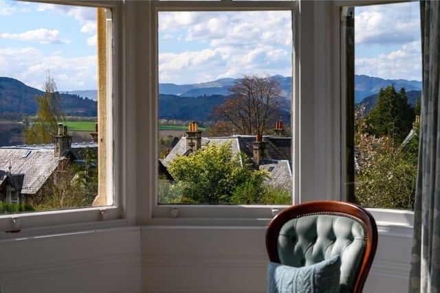 The turret windows of the principal bedroom capture a far-reaching view towards Ben Vorlich and the hills beyond.