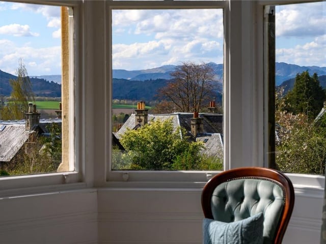 The turret windows of the principal bedroom capture a far-reaching view towards Ben Vorlich and the hills beyond.