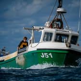 Fishermen processing their catch of lobster and crab on the deck of their boats. Picture: Ben Birchall/PA Wire