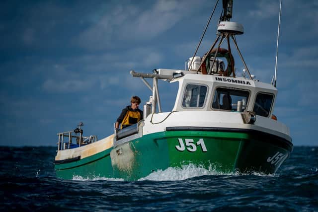 Fishermen processing their catch of lobster and crab on the deck of their boats. Picture: Ben Birchall/PA Wire
