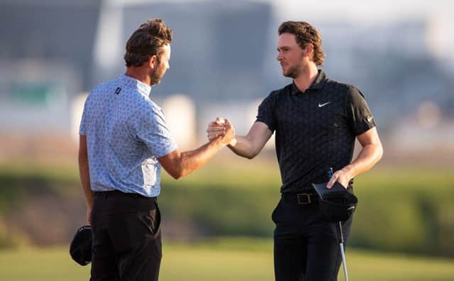 Scott Jamieson, left, congratulates Thomas Pieters after the final round of last year's Abu Dhabi HSBC Championship at Yas Links. Picture: Ryan Lim/AFP via Getty Images.